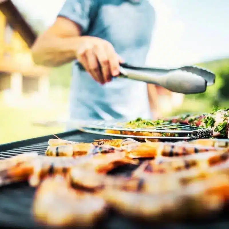 a person cooking food on a grill
